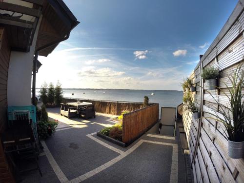 a balcony of a house with a view of the ocean at Apartamenty 5 metrów od morza in Rewa