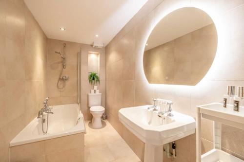 a bathroom with a sink and a tub and a toilet at 3Bed, 2Bath Penthouse Near Windsor & Long Walk in Windsor