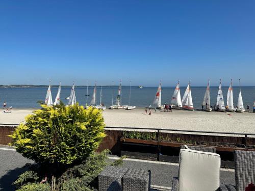a view of a beach with sail boats in the water at Apartamenty 5 metrów od morza in Rewa