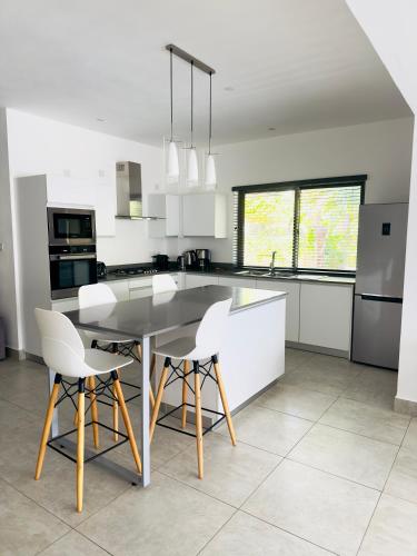 a kitchen with a table and chairs in a kitchen at Beach spot in Riambel