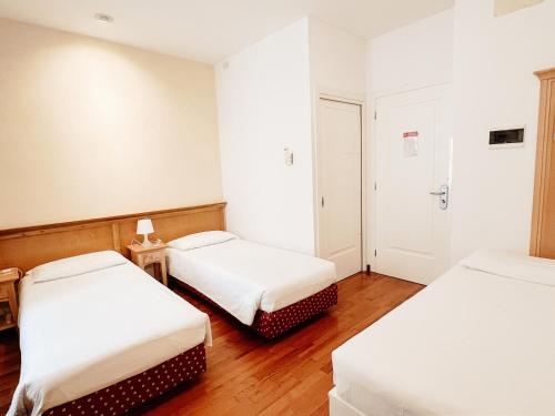 Postel nebo postele na pokoji v ubytování Gorizia Inn