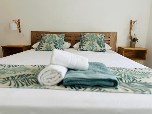 a bedroom with a bed with towels on it at Beach spot in Riambel