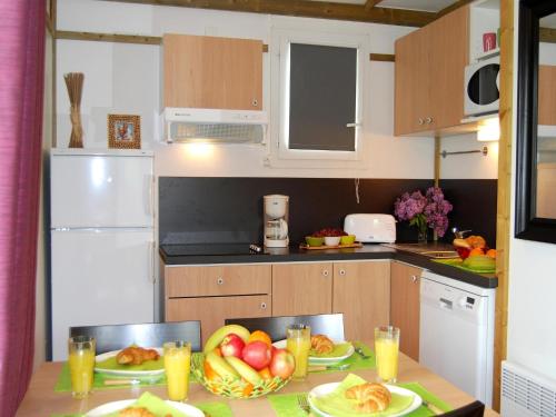 - une cuisine avec une table et des assiettes de fruits dans l'établissement Chalet in France with Garden Terrace, à Castelmoron-sur-Lot
