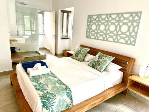 a bedroom with a large bed and a bathroom at Beach spot in Riambel