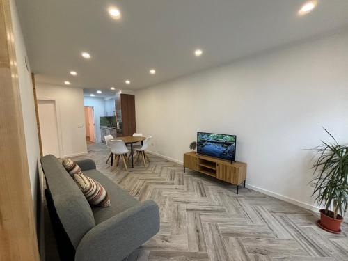 a living room with a couch and a flat screen tv at Charming Benavente in Benavente