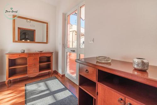 a room with a wooden dresser and a mirror at Ca du Muccin in Calice Ligure