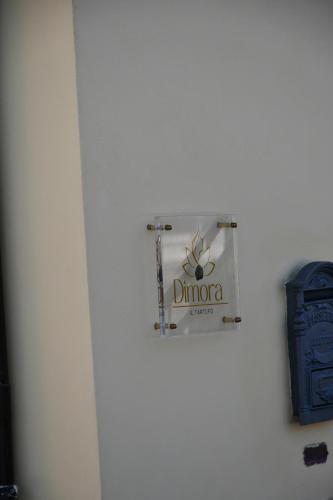 a sign on the side of a white wall at Dimora il Tartufo Relax e Benessere con Spa Privata in Busso
