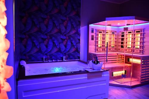 a bathroom with a bath tub with a window at Dimora il Tartufo Relax e Benessere con Spa Privata in Busso