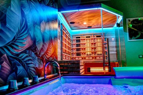 a room with a bath tub with a building mural at Dimora il Tartufo Relax e Benessere con Spa Privata in Busso