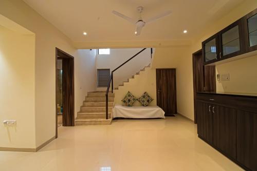 a hallway of a house with a bed and stairs at Mizzle Exotica Lonavala in Lonavala