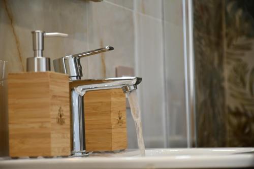 a bathroom sink with water coming out of a faucet at Dimora il Tartufo Relax e Benessere con Spa Privata in Busso
