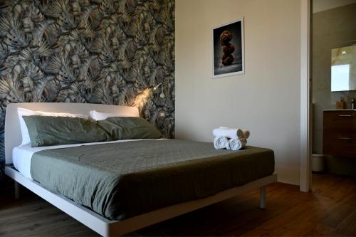 a bed with two stuffed animals sitting on it in a bedroom at Dimora il Tartufo Relax e Benessere con Spa Privata in Busso