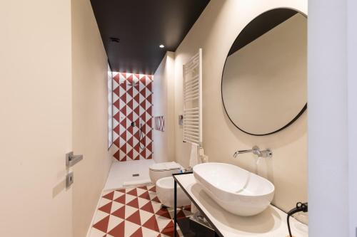 a bathroom with a sink and a mirror at Relais Ammira in Naples