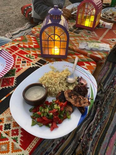 a plate of food with rice and vegetables on a table at Apadi camp in Port Ghalib