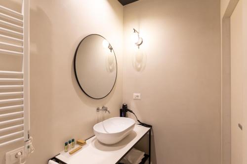 a bathroom with a sink and a mirror at Relais Ammira in Naples
