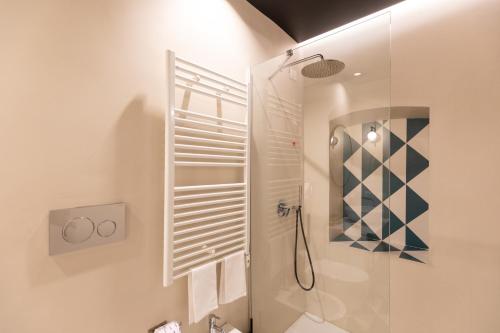 a bathroom with a shower and a glass shower stall at Relais Ammira in Naples