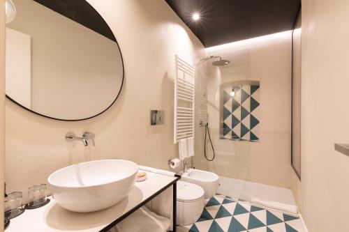 a bathroom with a sink and a mirror at Relais Ammira in Naples
