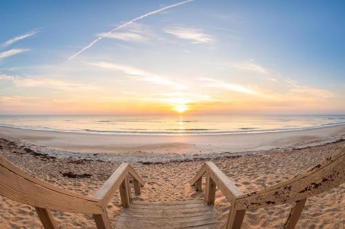 a hammock on the beach at sunset at Chadham by the Sea 413 in New Smyrna Beach
