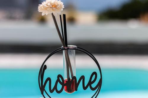 a flower in a holder with the word mum at Almodo Suite Puerto Rico in Puerto Rico de Gran Canaria