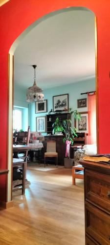 a living room with a table and a red wall at La Casita b&b in Bagnoregio