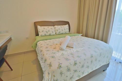 a small bedroom with a bed with a candle on it at Nature Home 2 - Swiss Garden Resort Residences Beachfront Villa in Kuantan