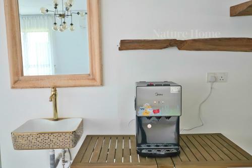 a small refrigerator sitting on a table in a room at Nature Home 2 - Swiss Garden Resort Residences Beachfront Villa in Kuantan