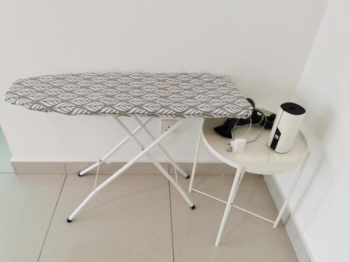 a white table and a white chair in a room at Nature Home 2 - Swiss Garden Resort Residences Beachfront Villa in Kuantan
