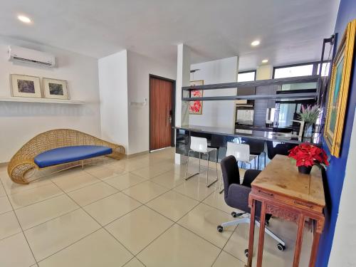a living room with a couch and a table and chairs at Nature Home 2 - Swiss Garden Resort Residences Beachfront Villa in Kuantan
