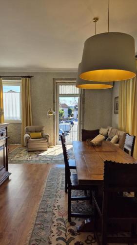 a living room with a wooden table and a dining room at Casas São Tiago - Arouca, conforto e natureza in Arouca