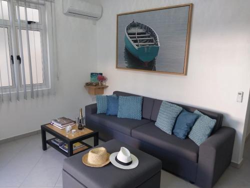 a living room with a couch and a table at Sunshine Residence Holiday Apartments Mauritius in Poste Lafayette