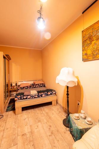 a room with two beds and a lamp in it at Apartament ,,Kraina Alicji'' in Wałbrzych