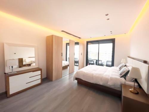 a large bedroom with a bed and a mirror at Luxurious 3BR 2BA, 5-min to Beach, Large Terrace, High Floor in Tangier