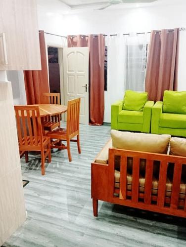 a living room with a couch and a table and chairs at Mag home in Porto-Novo