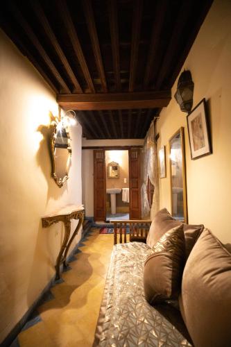 a living room with a couch and a table at Riad Louna Fes & Spa in Fès