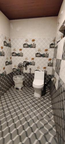 a bathroom with a toilet and a sink at Halli Hithalu Homestay in Chikmagalūr