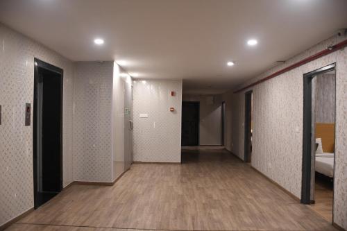 an empty hallway with a hallway leading to a room at SwagStay Hotel OwnHouse 181 Nagpur in Nagpur