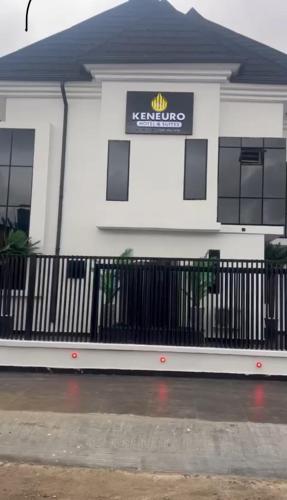 a white building with a sign on it at Keneuro hotel & suites in Lagos