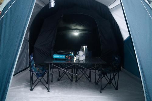 a table sitting inside of a tent with a table at Levi Camp in Brujul