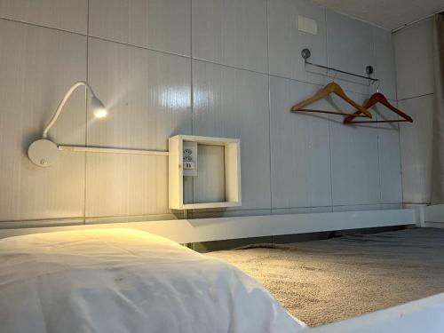 a bedroom with a bed and a small mirror at Hostel Feminino Sol de Maria in Salvador