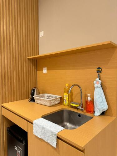 a kitchen counter with a sink and a sink at Cozy suite-The Shore in Kota Kinabalu