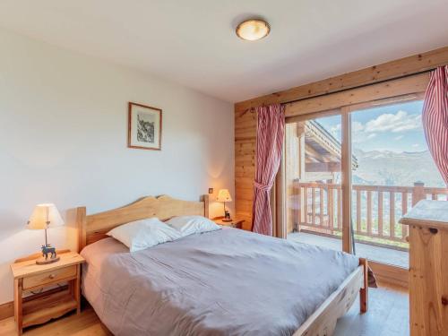 a bedroom with a bed and a large window at Appartement spacieux 8 pers, parking, ski aux pieds - FR-1-352-79 in Arc 1800
