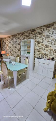 a kitchen with a table and chairs in a room at شقه باطلاله شاطي عجمان in Ajman
