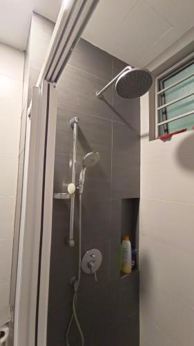 a bathroom with a shower with a shower head at Peacehome 18 in Cyberjaya