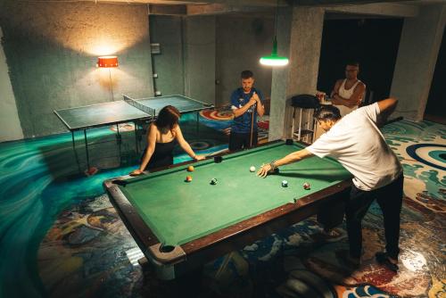 a group of people playing a game of billiard at Hostel Hasta La Vista in Sarandë