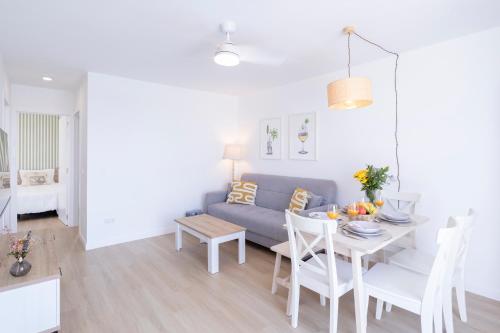 a living room with a couch and a table at Casa Hortencia - Beautiful seaside apartment - Puerto de Las Nieves in Agaete