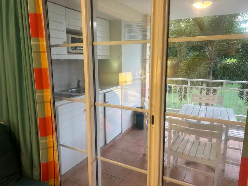 a room with sliding glass doors and a balcony at la Désirade in Sainte-Luce