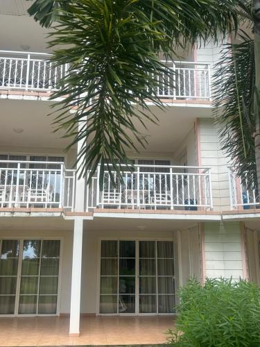 a building with a palm tree in front of it at la Désirade in Sainte-Luce