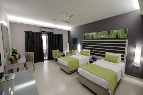 Postel nebo postele na pokoji v ubytování Regenta Baywatch Resort, Goa