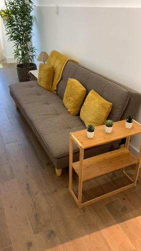 a living room with a couch and a table at Encanto Casa com Spa Jacuzzi Open Space in Tinalhas