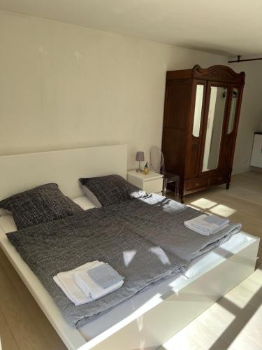 a bedroom with a large bed and a dresser at Schloss Suggenstein in Sigmaringen